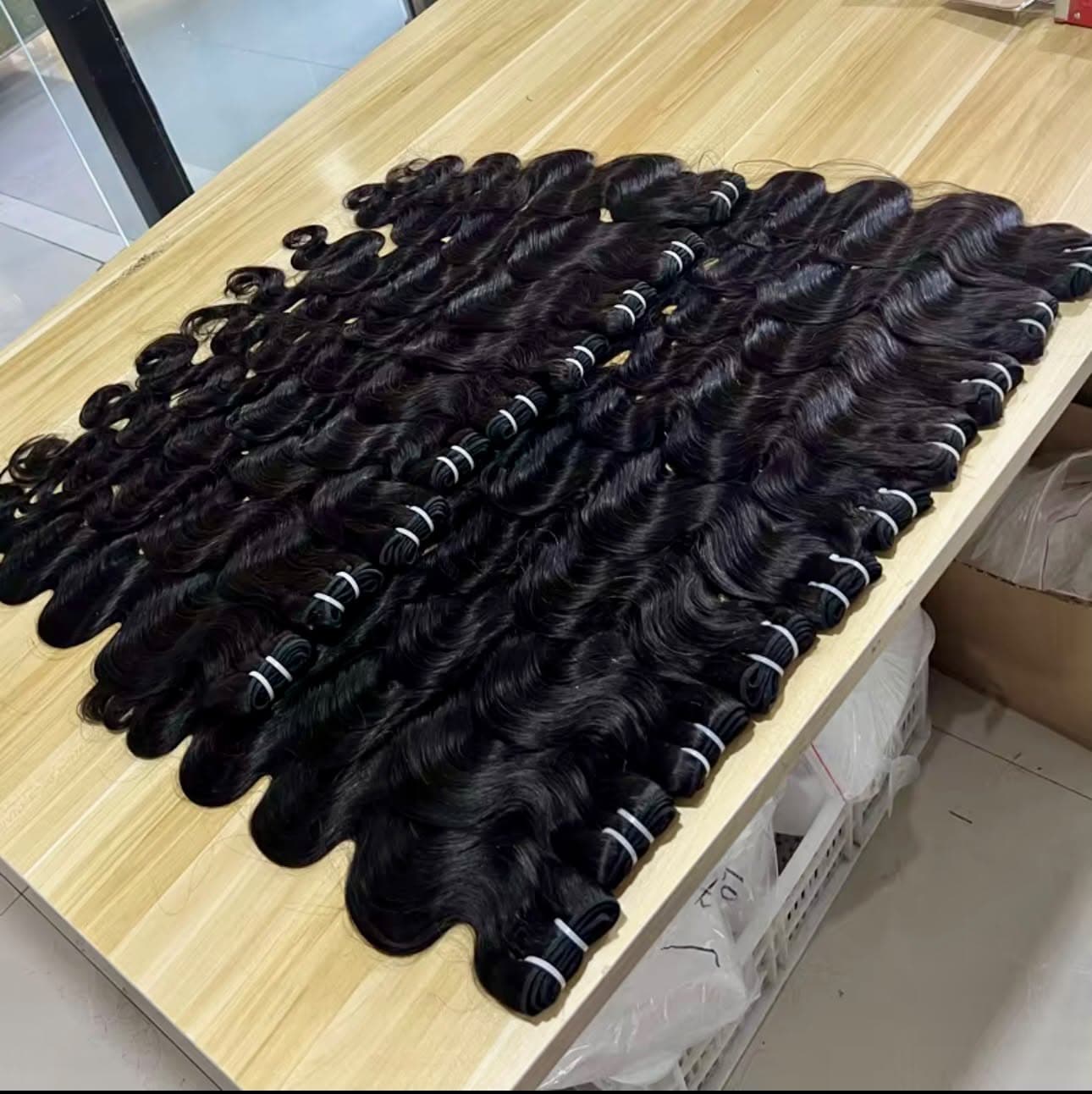 Rows of body wave bundles prepared as stock